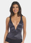 A woman wearing a doppio low plunge top with adjustable straps and a deep V-neckline.