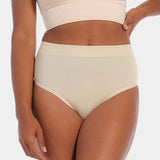 Front view of a model wearing the Comfort Thong, showcasing the soft, seamless fabric with light shaping through the lower tummy and a smooth, invisible finish under clothing.