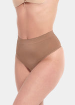 Front view of a model wearing the Macchiato Comfort Thong, showcasing the soft, seamless fabric with light shaping through the lower tummy and a smooth, invisible finish under clothing.