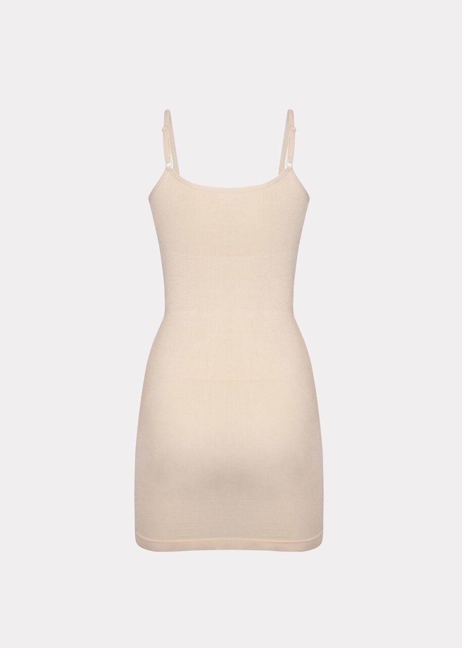 Still product image of Seamless Bodydress in latte shown from the back. Body-contouring shaping dress with smooth seamless fabric, medium shaping for lower back and hips, adjustable spaghetti straps, and silicone-trimmed hem visible.