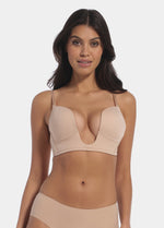 This image features a model wearing a V-Bra, which is designed to be nearly invisible under clothing with low plunge necklines. The bra boasts a deep cleavage front and an extra low back, making it ideal for seamless coverage.