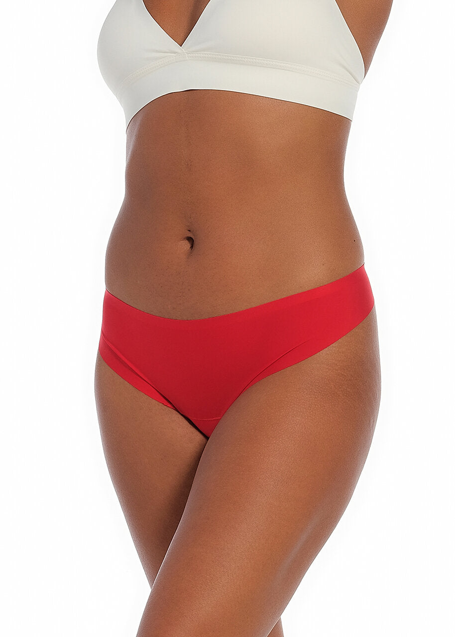 A red thong underwear featuring smooth, seamless fabric with laser-cut edges, and a cotton crotch lining.