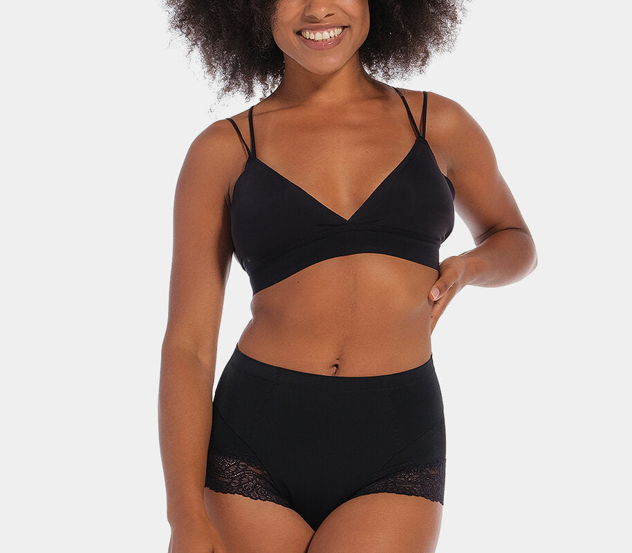 Black mid-waist shaping brief worn by a model in a front-facing standing position, featuring firm lower tummy and back shaping with built-in powernet support, smooth strong breathable fabric, flat invisible lace, and cotton gusset lining.