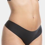 A model wearing the black thong underwear featuring smooth, seamless fabric with laser-cut edges, and a cotton crotch lining.
