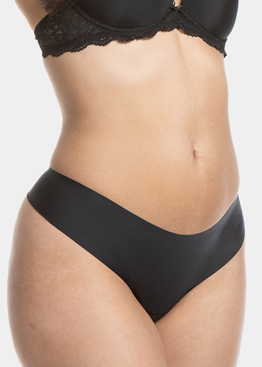 A model wearing the black thong underwear featuring smooth, seamless fabric with laser-cut edges, and a cotton crotch lining.