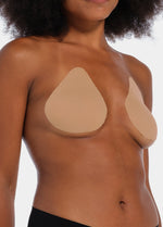 Front view of a model wearing the caramel-colored Beverly Hills Secret breast lift tapes, showcasing the ultra-thin adhesive tapes that lift and support the bust while creating a smooth, invisible look under clothing.