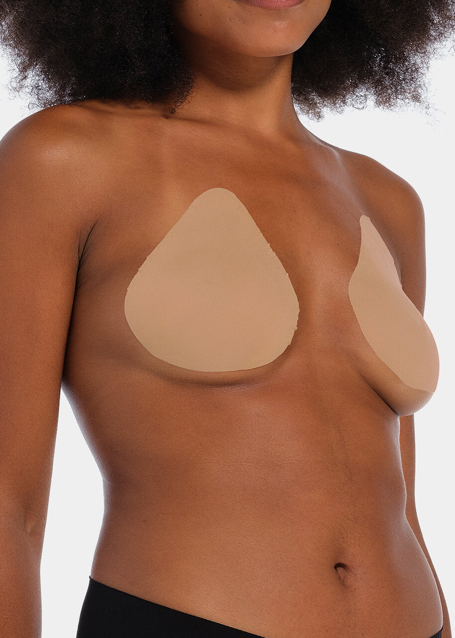Front view of a model wearing the caramel-colored Beverly Hills Secret breast lift tapes, showcasing the ultra-thin adhesive tapes that lift and support the bust while creating a smooth, invisible look under clothing.