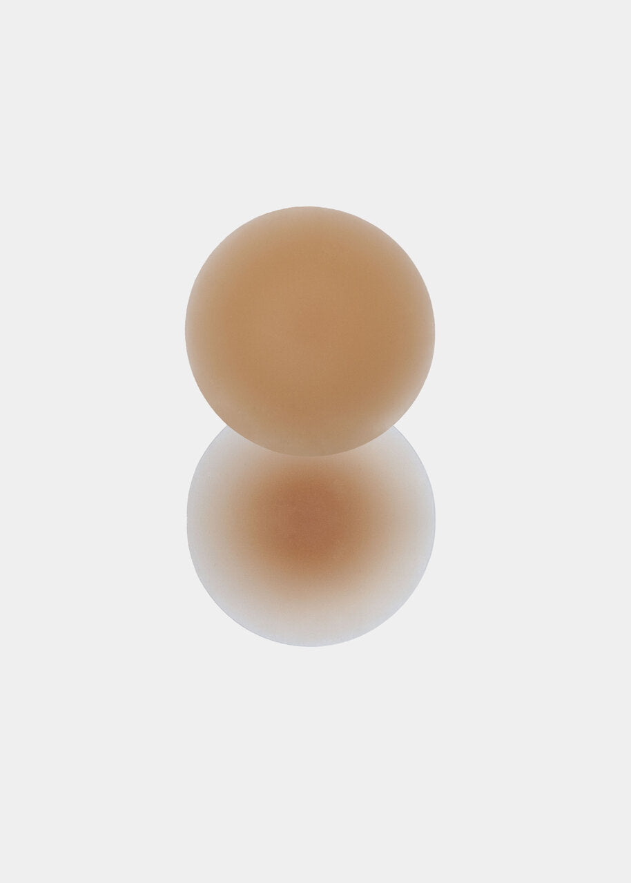 Still product image of the caramel-colored MAGIC Nipples silicone nipple covers, showcasing the ultra-thin, soft covers designed for discreet, invisible coverage without adhesive.