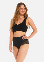 This image features a woman modeling a black, sleeveless tummy shaper lace garment. The design includes a wide band at the waist, for better fit and support.