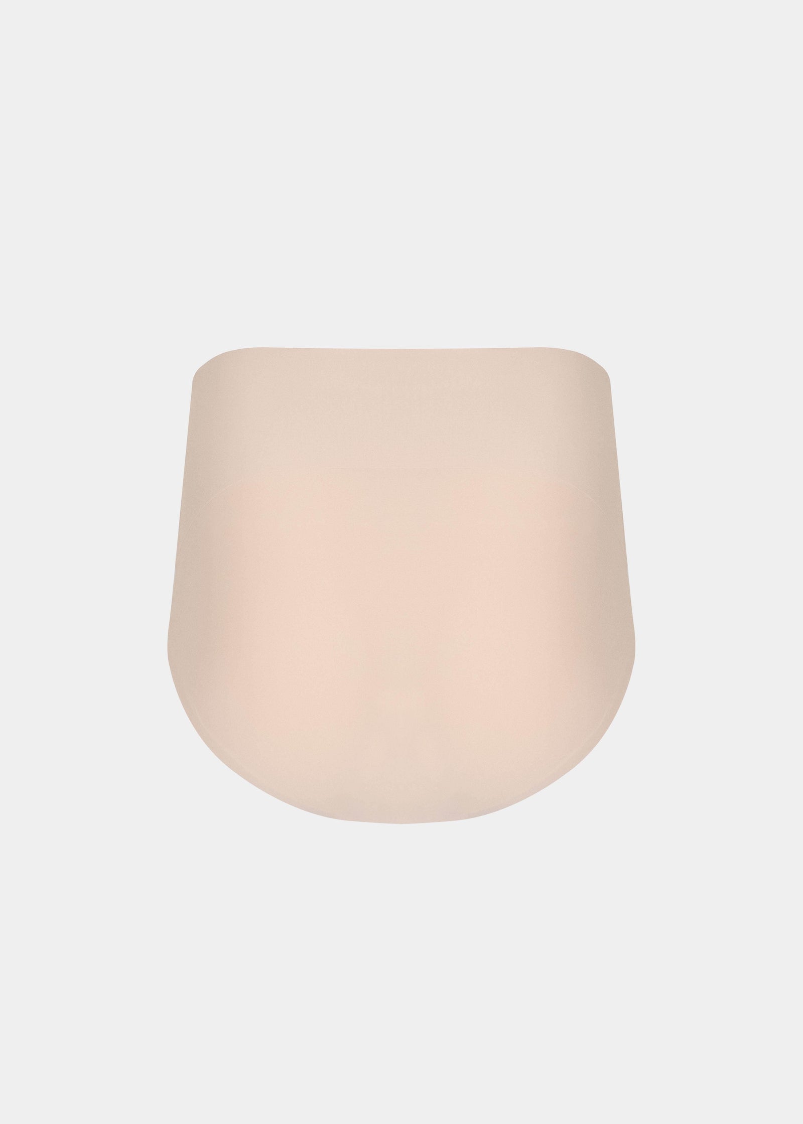 Still product image of Tummy Shaper in latte shown from the back. Mid-waist shaping brief with smooth, seamless fabric, full back coverage, and invisible edges for firm shaping at the lower back.