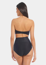 Back view of a model wearing Tummy Shaper in black, mid-waist shaping brief with seamless design. Smooth fabric with full back coverage and invisible edges, providing firm shaping at the lower back.