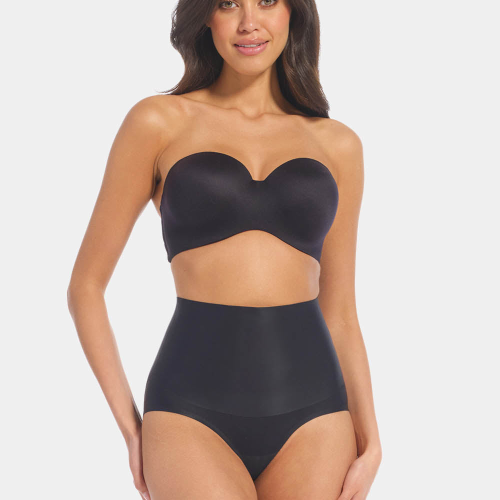 Front view of a model wearing Tummy Shaper in black, mid-waist shaping brief with double-layer waistband. Seamless design with smooth fabric and full front coverage, providing firm shaping at the tummy area.