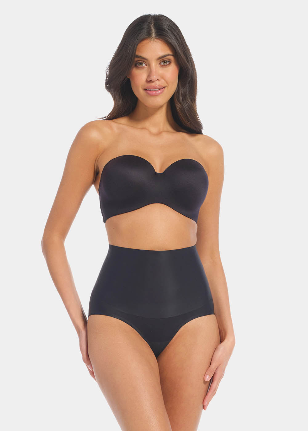 Front view of a model wearing Tummy Shaper in black, mid-waist shaping brief with double-layer waistband. Seamless design with smooth fabric and full front coverage, providing firm shaping at the tummy area.