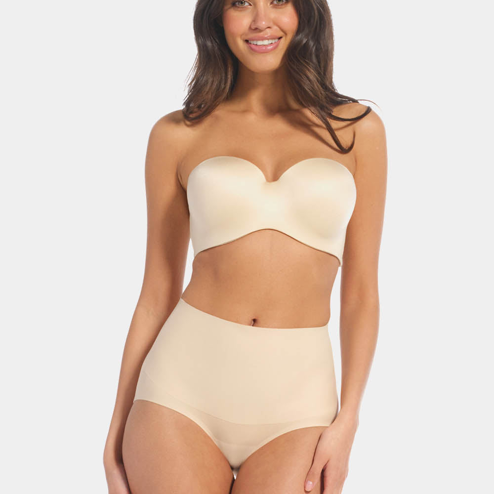 Front view of a model wearing Tummy Shaper in latte, mid-waist shaping brief with double-layer waistband. Seamless design with smooth fabric and full coverage front, providing firm shaping at the tummy area.