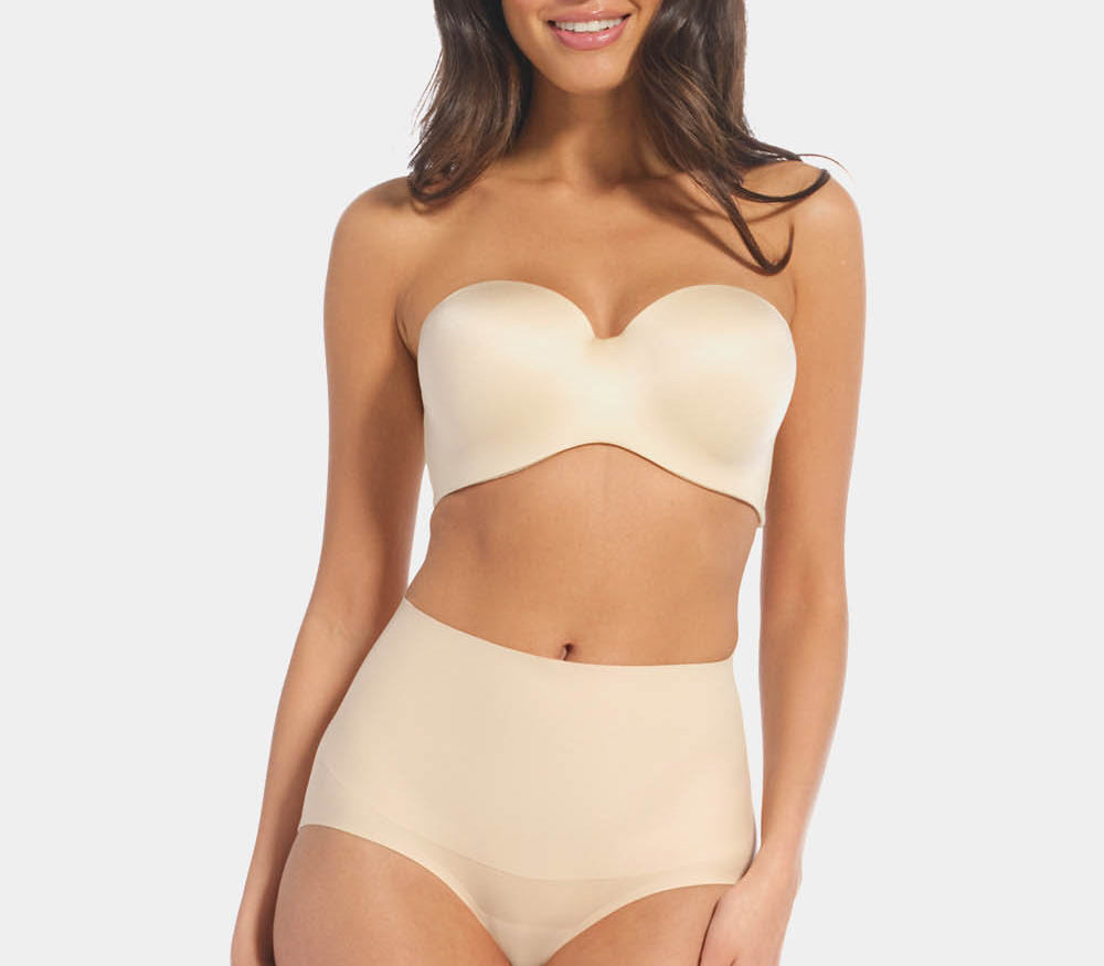 Front view of a model wearing Tummy Shaper in latte, mid-waist shaping brief with double-layer waistband. Seamless design with smooth fabric and full coverage front, providing firm shaping at the tummy area.