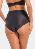 Back view of a model wearing Everyday Shaper Brief in black, mid-waisted seamless shapewear brief. Smooth, lightweight fabric with full back coverage and seamless edges, designed for invisible shaping under clothing.