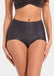 Front view of a model wearing Everyday Shaper Shorty in black, mid-waisted seamless shapewear shorts. Cropped image showing waistband and upper thigh area, with smooth fabric and seamless finish for invisible shaping under clothing.