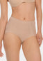 Front view of a model wearing Everyday Shaper Shorty in cappuccino, mid-waisted seamless shapewear shorts. Smooth fabric with short leg length, providing light shaping to lower tummy and back with invisible finish under clothing.