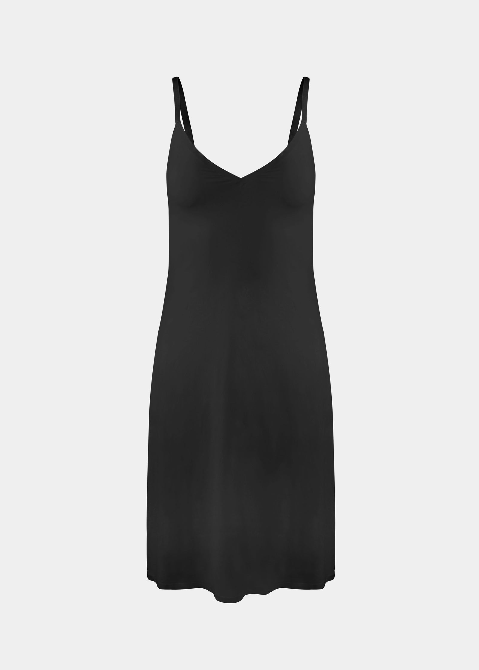 Still product image of Everyday Underdress in black, lightweight underdress with V-neckline and adjustable straps. Smooth, flowy fabric with relaxed fit and mid-thigh length, designed as an invisible base layer under clothing.