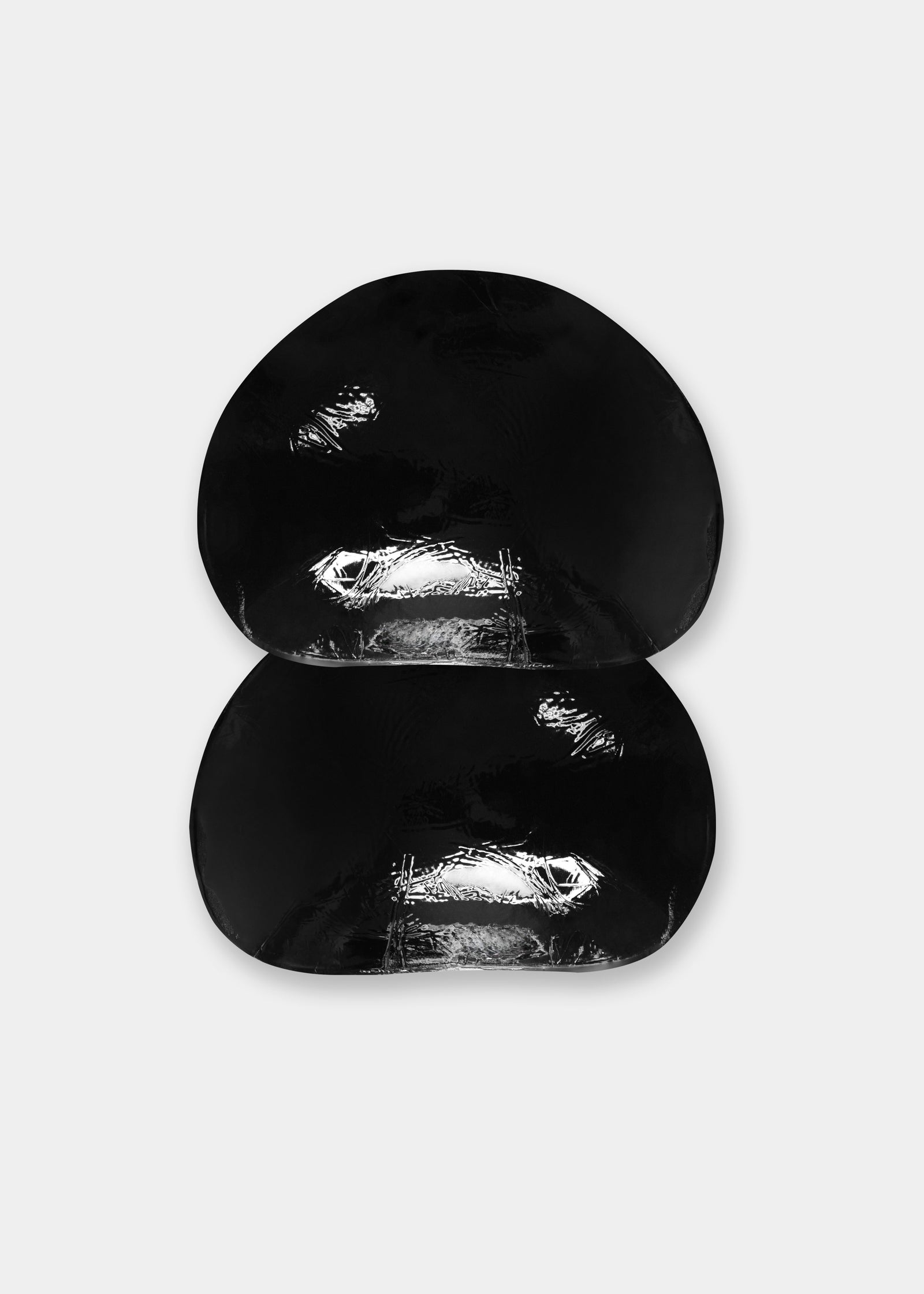 Still product image of Double Sticky Demi Push-Up Pads in black, demi-shaped silicone bra inserts. Curved pads with smooth outer surface and seamless edges, designed for adhesive placement inside a bra for lift and support.