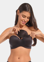 Front view of a model inserting Watersoft Push-Up Bra pads in black, water and oil-filled bra inserts. Full cup pad placed inside bra, showing added volume with smooth surface and curved shape.