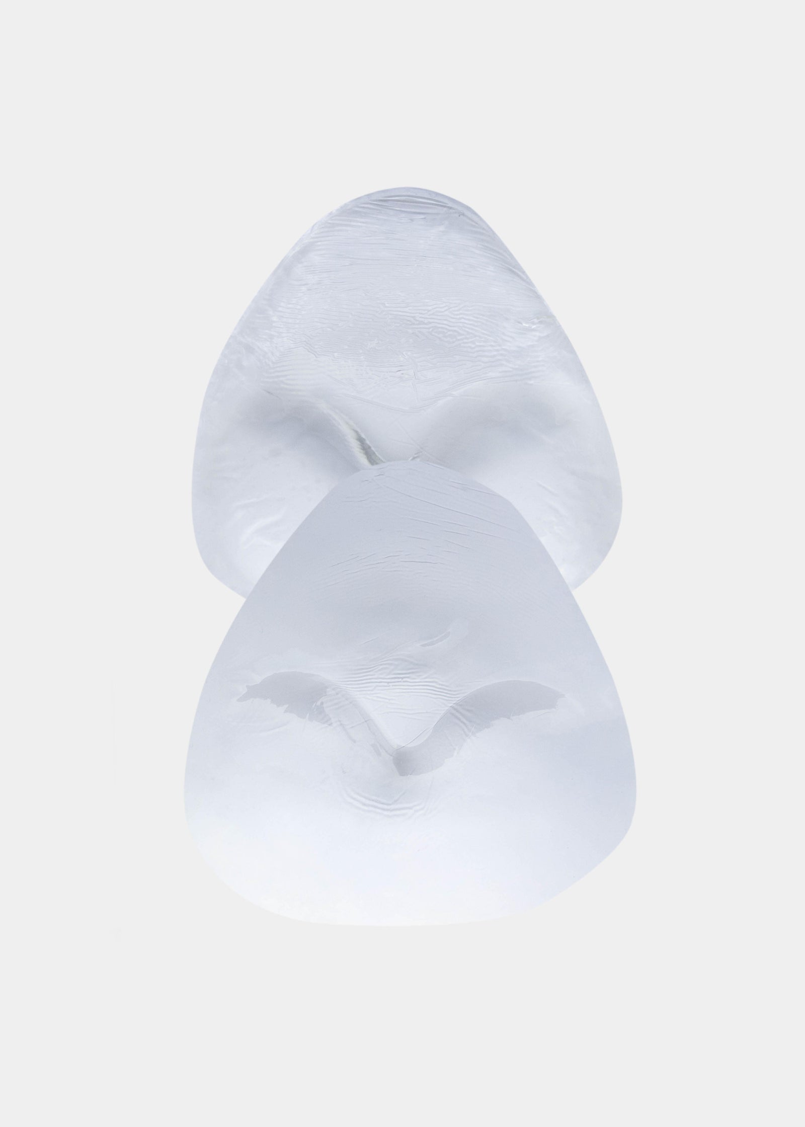 Still product image of Bikini Swim Pad in clear, silicone adhesive push-up pads. Transparent pads with smooth surface and curved shape, designed for use inside bikini or swimwear to add lift and volume.