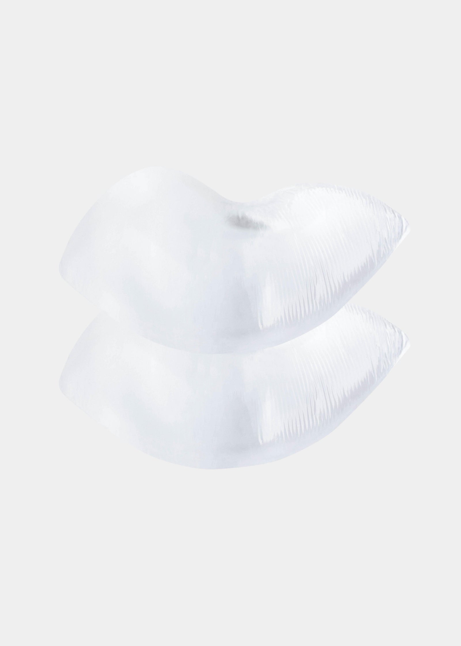Still product image of Silicone Curves in clear, transparent silicone push-up pads. Crescent-shaped inserts with smooth surface and seamless edges, designed to be placed inside a bra for added lift and volume.