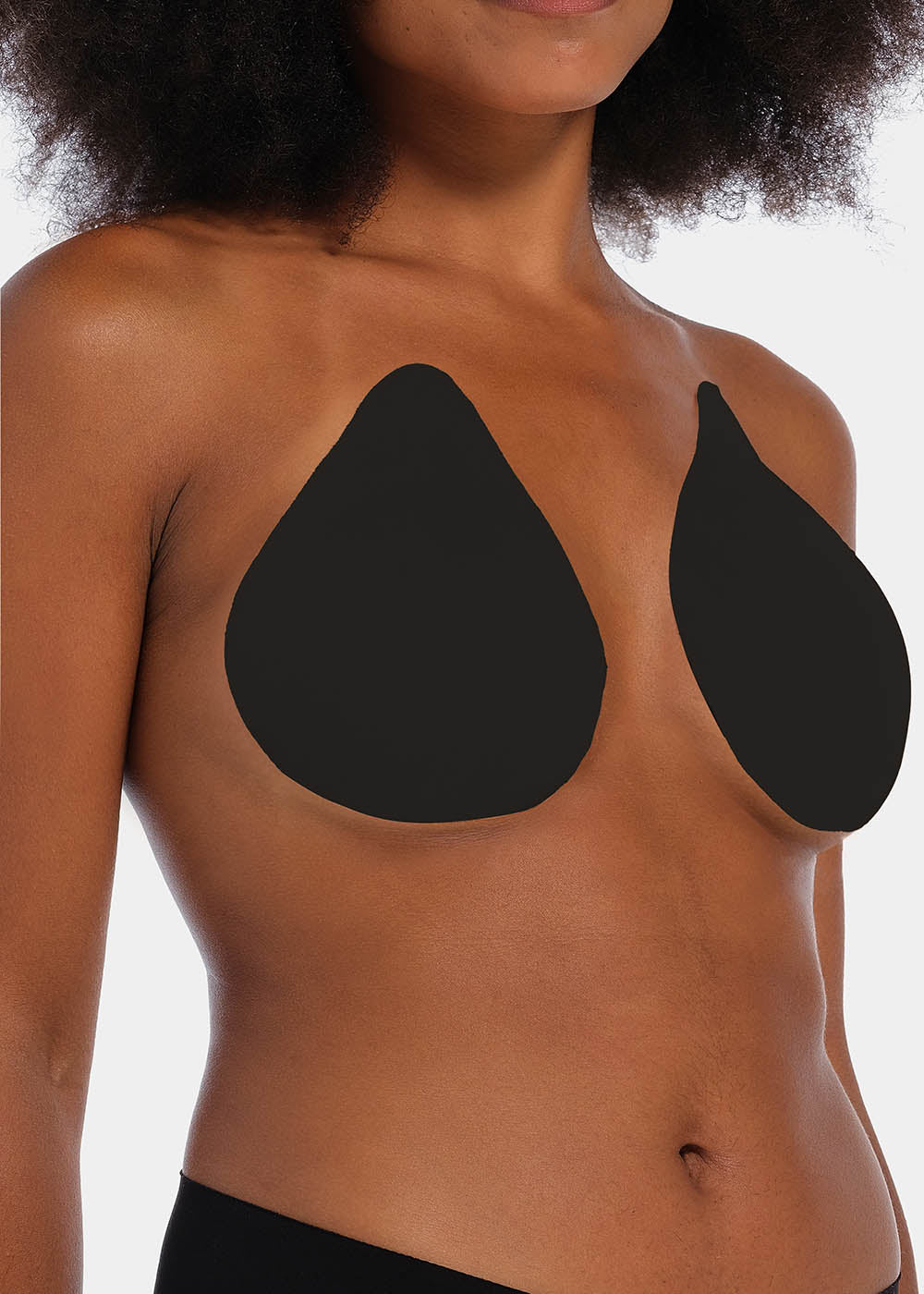 Front view of a model wearing the black Beverly Hills Secret breast lift tapes, showcasing the ultra-thin adhesive tapes that lift and support the bust while creating a smooth, invisible look under clothing.