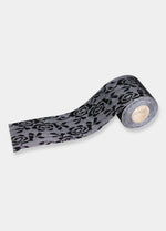 Still product image of the black Luxury Lace Boob Tape, showcasing the roll of lace-finish adhesive tape designed to lift and shape the bust.