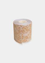 Still product image of the caramel-colored Luxury Lace Boob Tape rolled up, highlighting the lace-textured adhesive tape on a roll for lifting and shaping the bust.