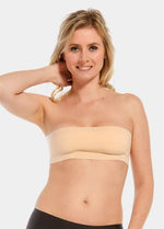 Front view of a model wearing the latte-colored MAGIC Bodyfashion Breast Tape, showcasing the adhesive tape applied to lift and shape the bust while creating a smooth, invisible look under clothing.