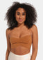 A woman wearing a mocha strapless top made with adhesive boob tape.
