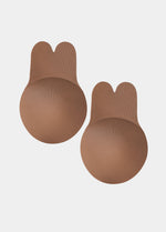 Still front product view of the mocha-colored Lift Covers, showcasing the smooth lifting nipple covers with adhesive support tabs and a seamless finish for invisible coverage.