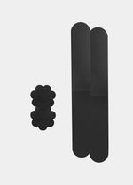 Still product image of the black Celebrities Breast Tape, showcasing the adhesive breast tape pieces designed to lift and support the bust for a smooth, invisible look under clothing.