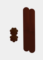 Still product image of the chocolate-colored Celebrities Breast Tape, showcasing the adhesive breast tape pieces designed to lift and support the bust for a smooth, invisible finish under clothing.