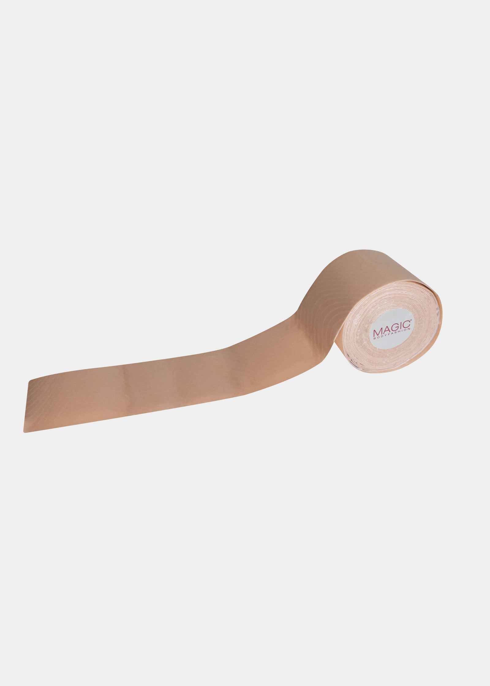 A roll of beige-colored double-sided sticky tape, likely used for adhesive purposes in fashion or cosmetics.
