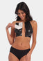 A woman demonstrating the use of double sticky boob tape to lift and shape the breasts, providing a seamless look under clothing.