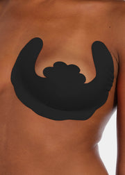 Front view of a model wearing the black Freedom Form adhesive breast lift strips, showcasing the strapless and backless design that lifts and supports the bust while remaining invisible under clothing.
