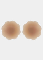 Still product image of Flower Nipples in caramel, flower-shaped silicone nipple covers showing the inside surface. Smooth silicone interior with molded center and seamless edges, designed to create a vacuum effect over the nipple area.