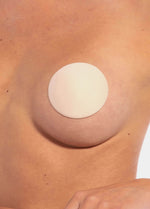 Close-up front view of the latte-colored MAGIC Hide Your Nipples covers, highlighting the soft fabric surface and smooth, ultra-thin edges for discreet, invisible coverage.
