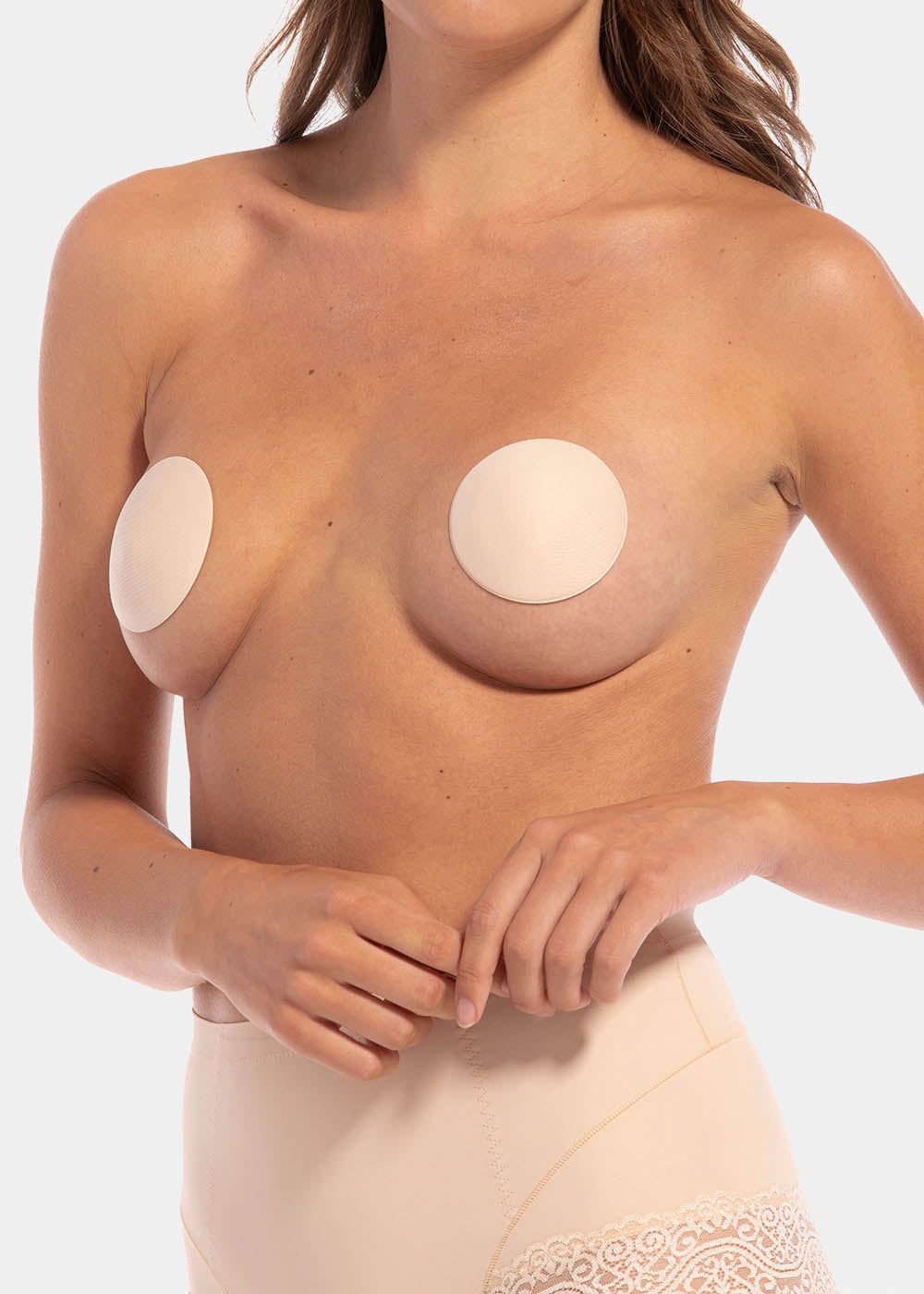 Front view of a model wearing the latte-colored MAGIC Hide Your Nipples covers, showcasing the soft fabric nipple covers that provide smooth, discreet coverage with a natural, invisible look under clothing.