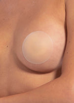 Ultra thin and soft skin-friendly silicone nipple covers worn by a model, appearing invisible under clothing.