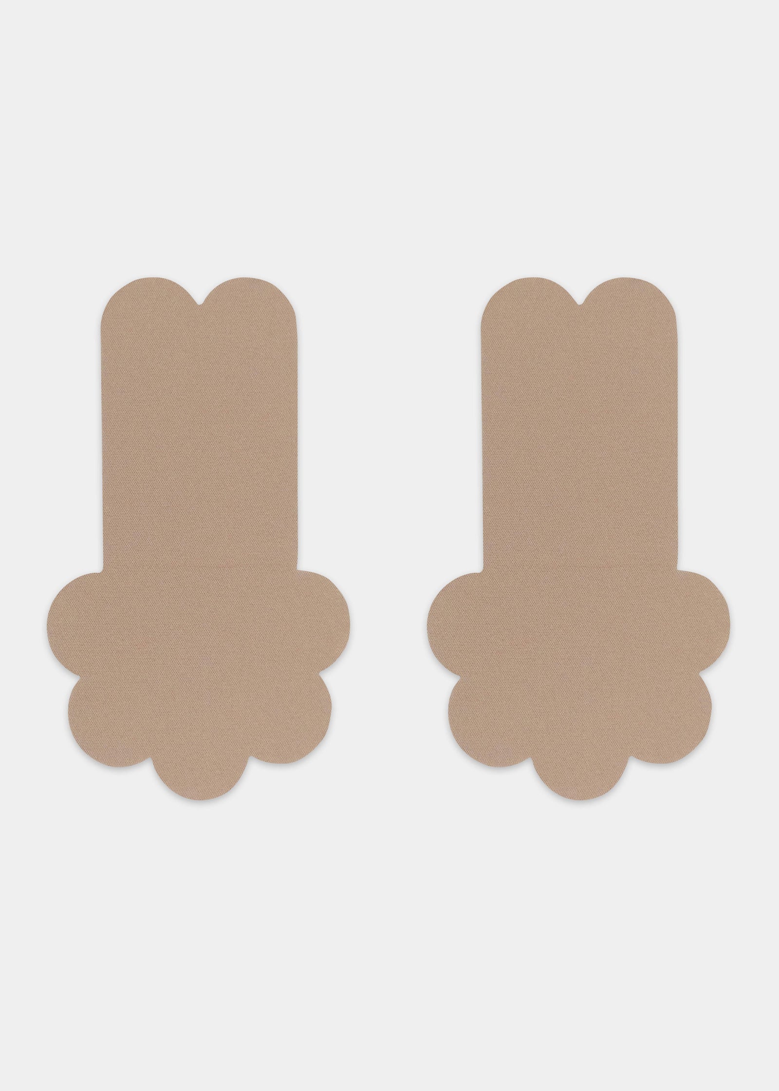 Still front product view of the caramel-colored Secret Lift Covers, showcasing the thin lifting nipple covers with adhesive support tabs and a smooth outer surface for an invisible finish.