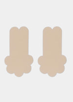 Still front product view of the latte-colored Secret Lift Covers, showing the thin lifting nipple covers with adhesive support tabs and a smooth outer surface for an invisible finish.