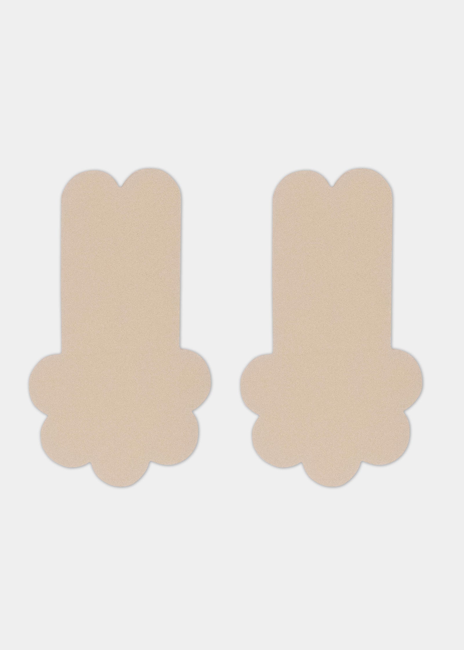 Still front product view of the latte-colored Secret Lift Covers, showing the thin lifting nipple covers with adhesive support tabs and a smooth outer surface for an invisible finish.