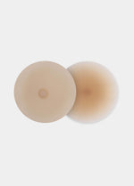 Still product image of the latte-colored Show Your Nipples silicone nipple covers, displayed overlapping to show both the smooth outer surface and the inner skin-friendly adhesive layer.