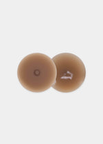 Still product image of the mocha-colored Show Your Nipples silicone nipple covers, displayed overlapping to show both the smooth outer surface and the inner skin-friendly adhesive layer.