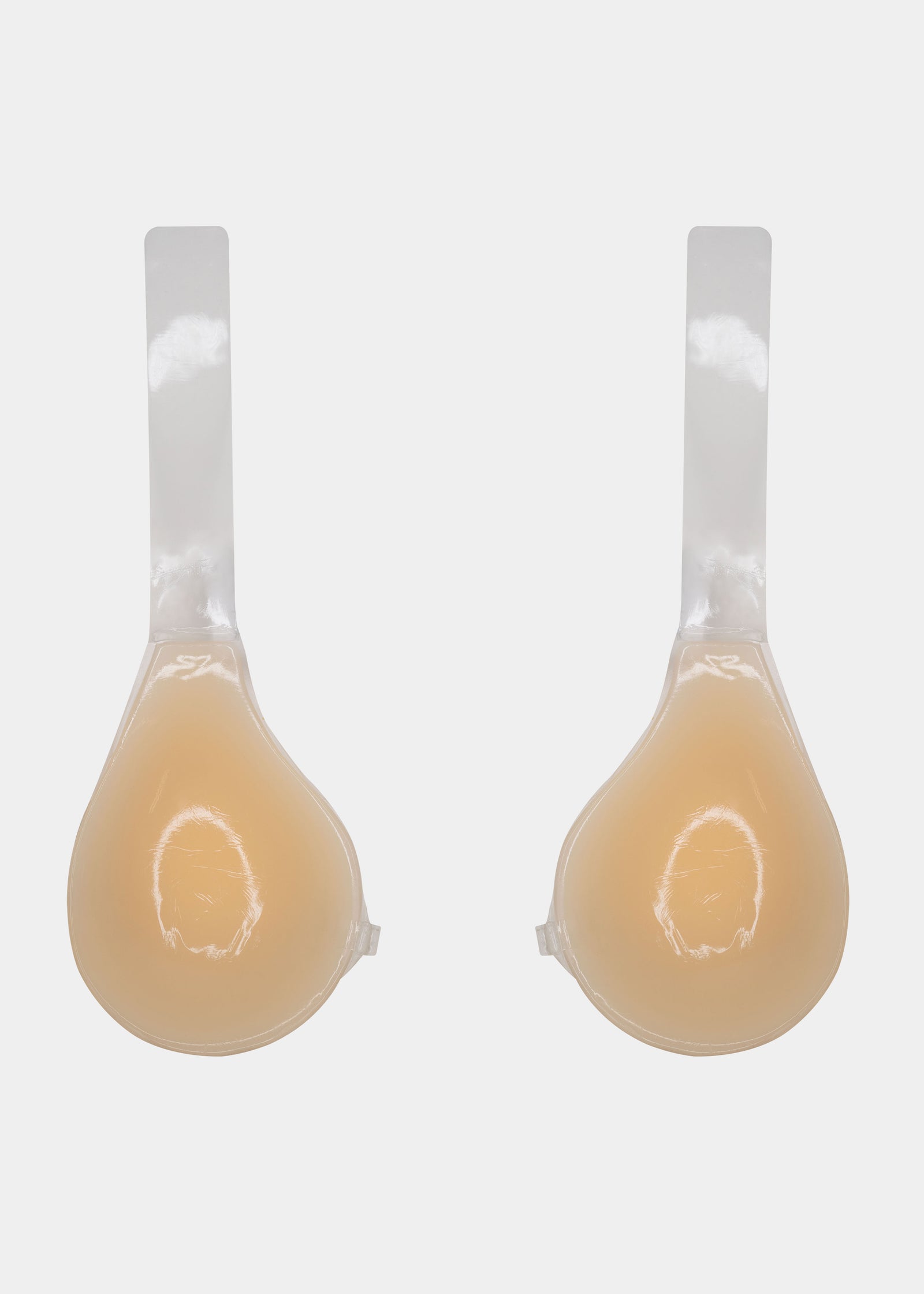 Still back product view of the latte-colored Shapely Bra with the front closure open, showing the separate silicone cups and transparent lifting straps with adhesive backing for invisible support.