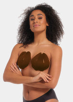 Front view of a model wearing the chocolate-colored Sculpting Breast Tape, showcasing the adhesive tape lifting and supporting the bust while creating a strapless, backless, and invisible look under clothing.