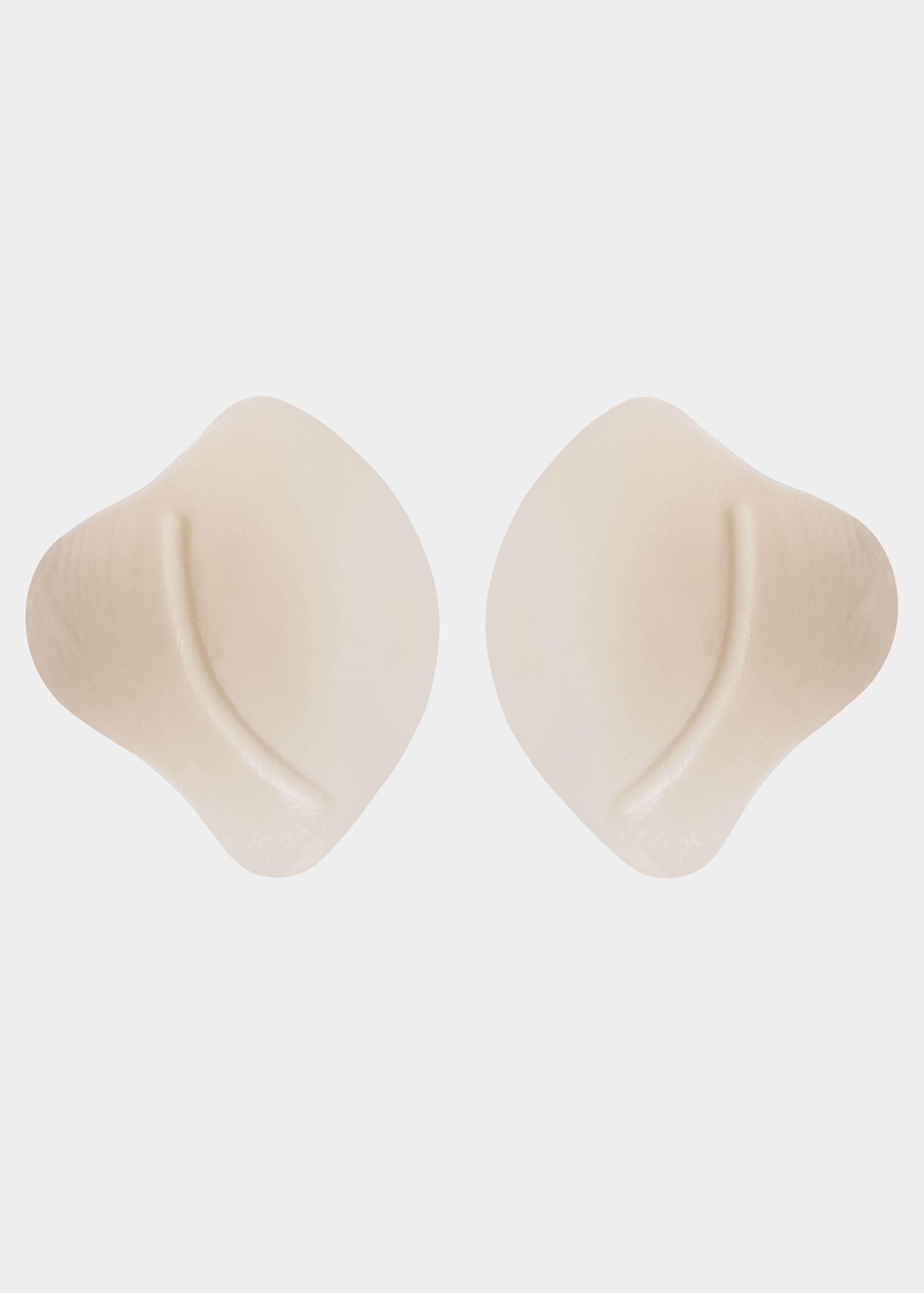 Close-up view of the inside of the Ultimate Invisibles bra cups, highlighting the skin-friendly adhesive layer with an adhesive-free center for added comfort and a smooth, lightweight construction.